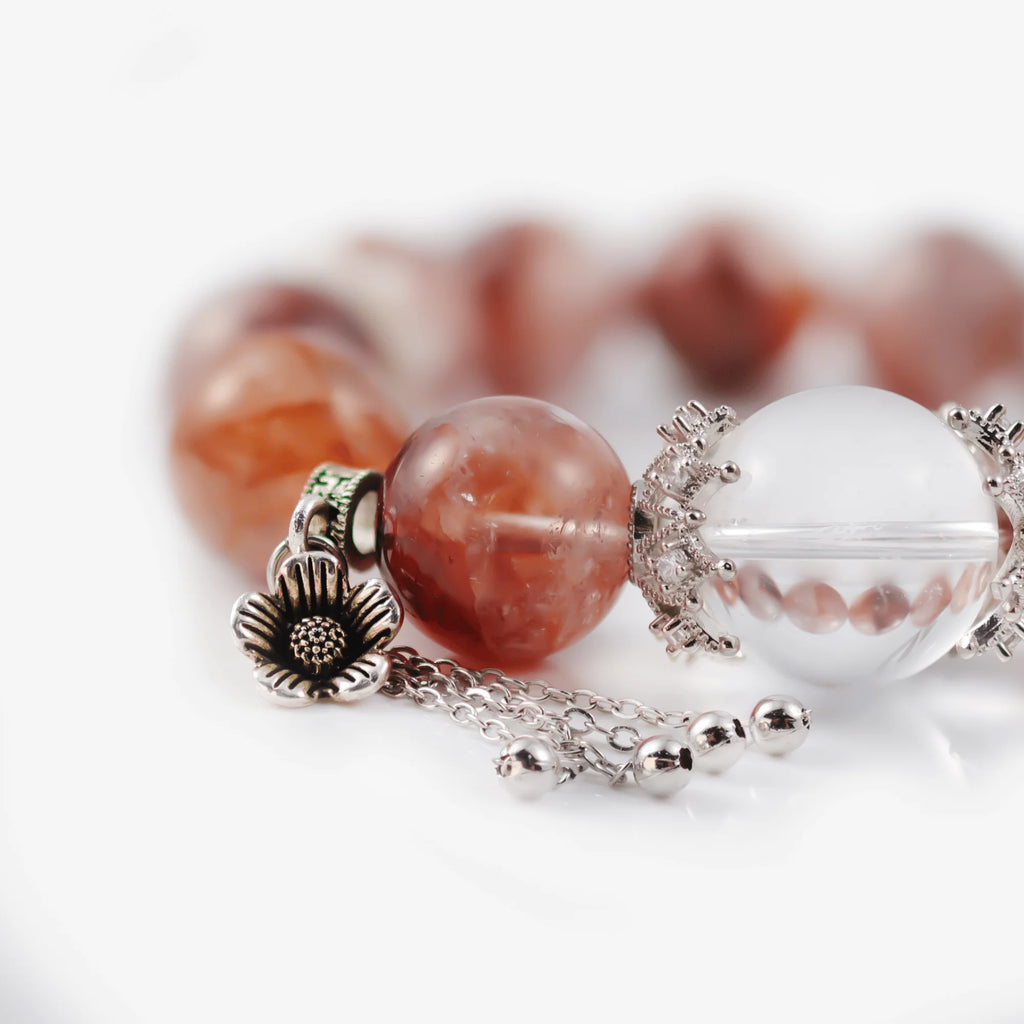 Cropped right-side half-view of the serene red hematoid quartz crystal bracelet on a pure white background.