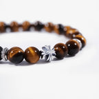 Cropped left-side half view of the natural tiger's eye cross bracelet on a pure white background.
