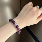 Close-up portrait view of the Eternal Elegant Amethyst Bracelet adorned on a woman hand with a shiny diamond ring.