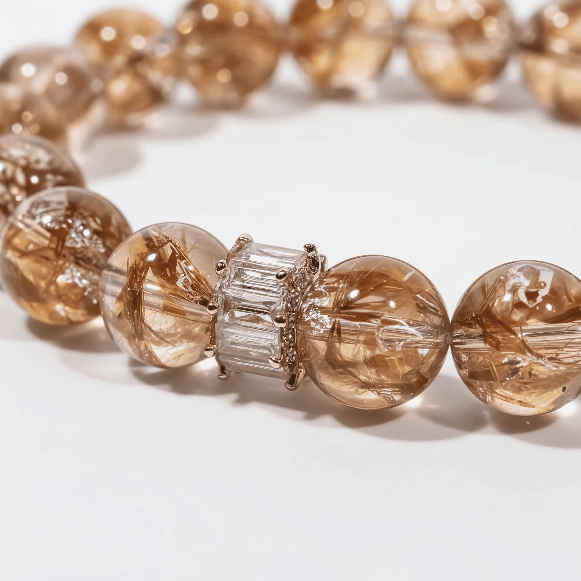Cropped right-side half-view of the lucky red hematoid quartz crystal bracelet on a pure white background.