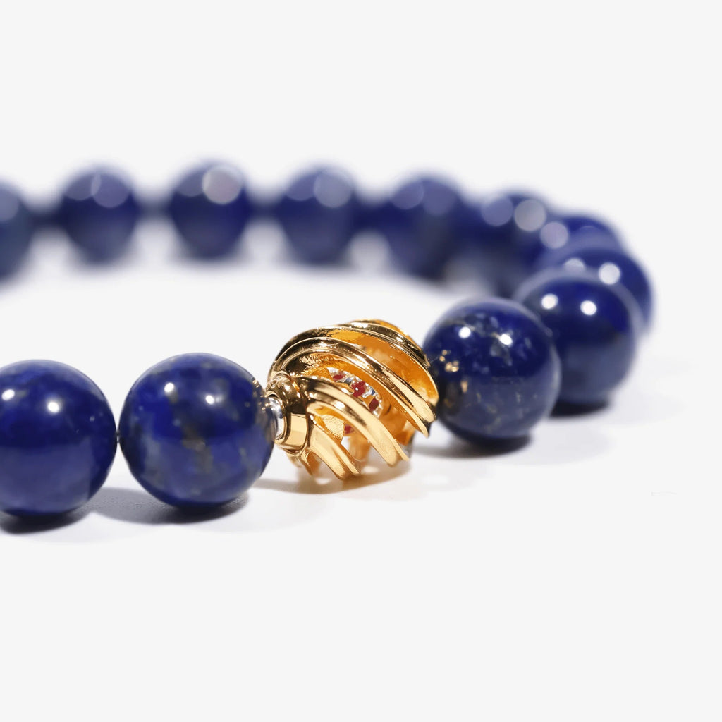 Cropped left-side half view of the protective blue lapis lazuli crystal bracelet on a pure white background.