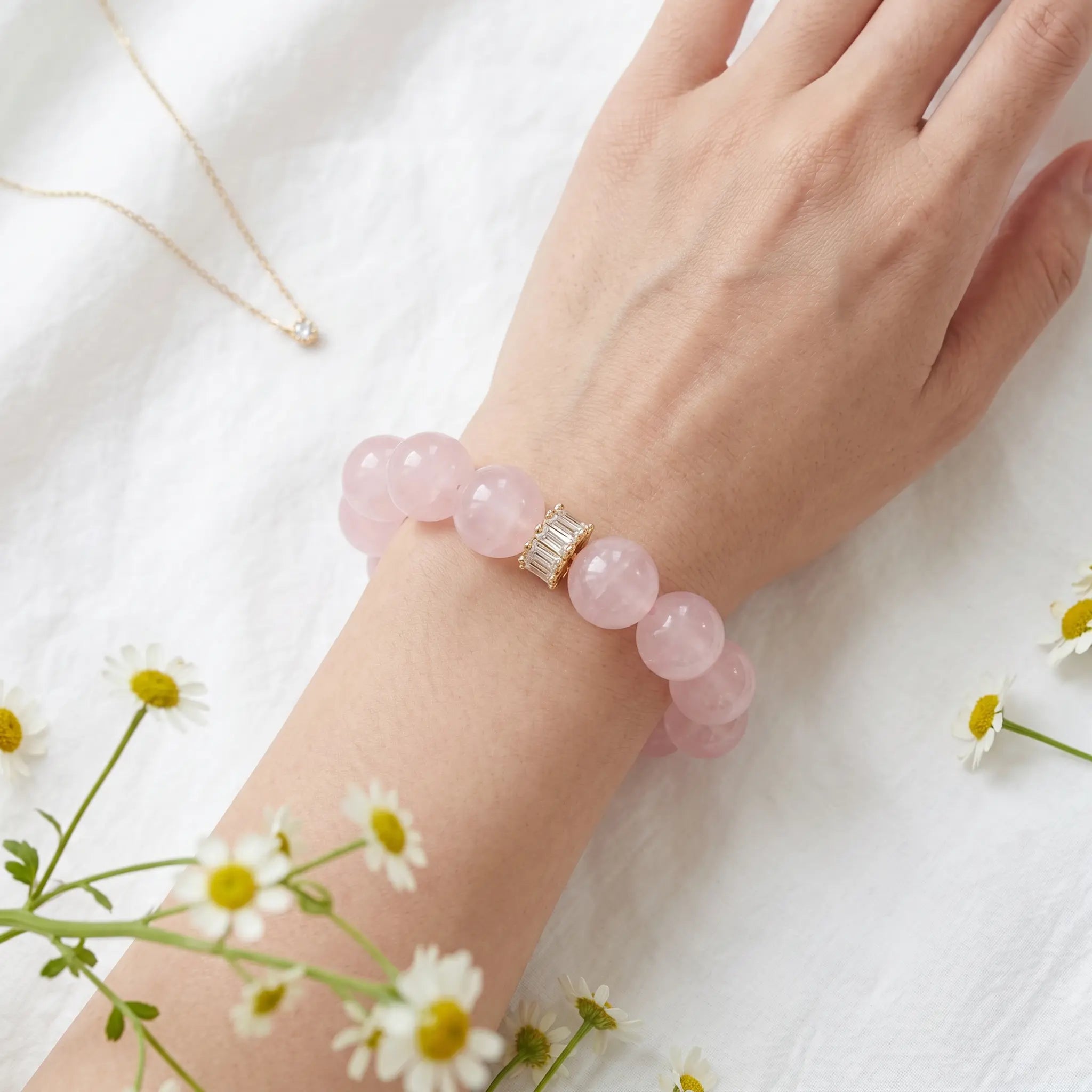 Macro detail view of the Harmony rose quartz gemstone bracelet resting gracefully on a gentle lady wrist.