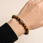 Studio product shot of Kailash Tiger's Eye Dzi Bracelet isolated on a clean white background.