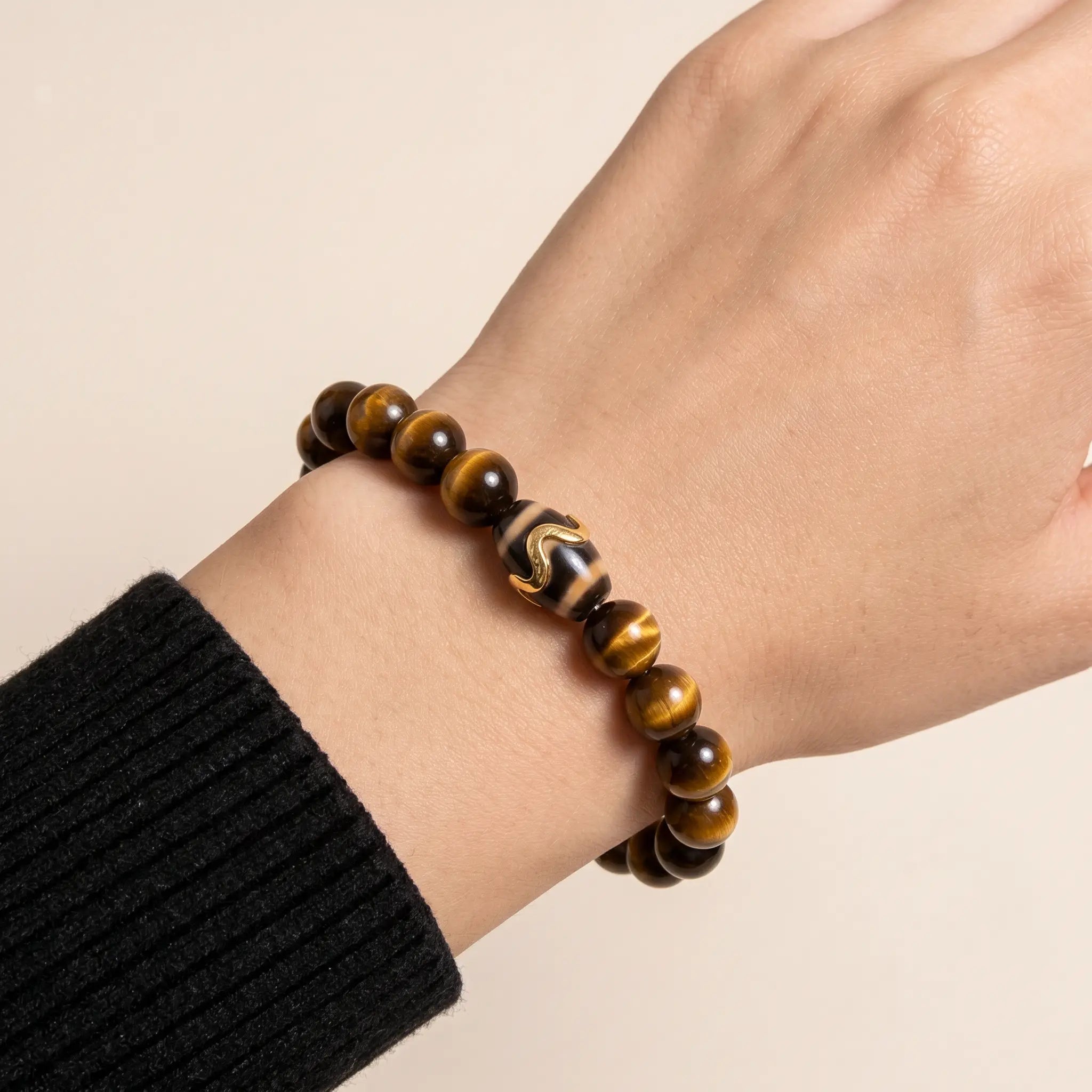 Studio product shot of Kailash Tiger's Eye Dzi Bracelet isolated on a clean white background.