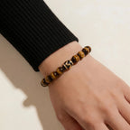 Detailed diagonal shot extending from upper-left to lower-right focusing on a mineral crystal bracelet with a patterned Dzi bead.