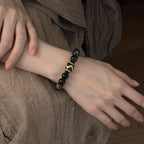 Studio product shot of Mystic Shield Obsidian Bracelet isolated on a clean white background.