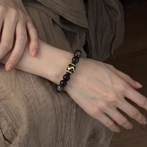 Studio product shot of Mystic Shield Obsidian Bracelet isolated on a clean white background.