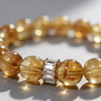 Centrally zoomed-in view of the radiant citrine crystal bracelet on a white background with cropped sides.
