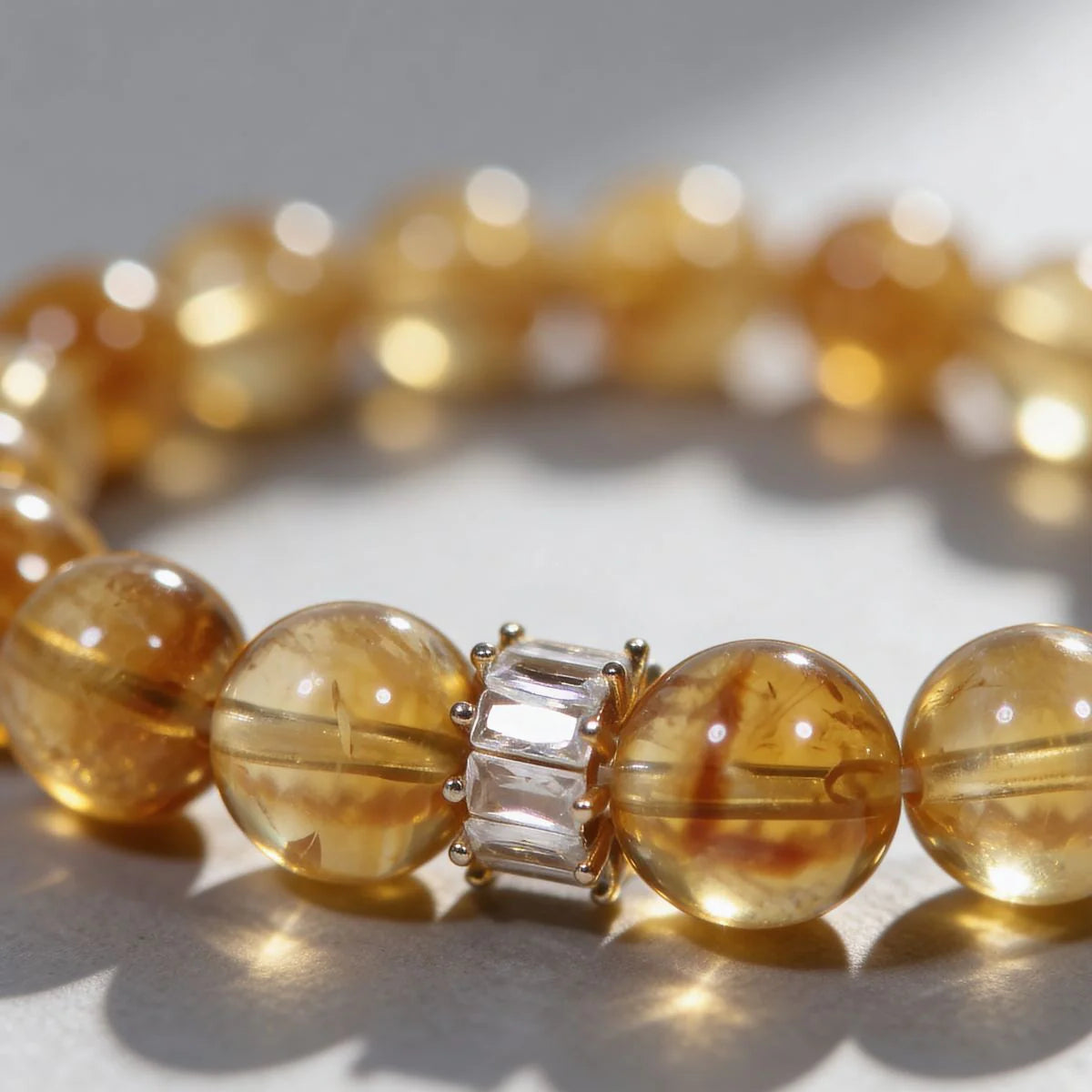 Centrally zoomed-in view of the radiant citrine crystal bracelet on a white background with cropped sides.