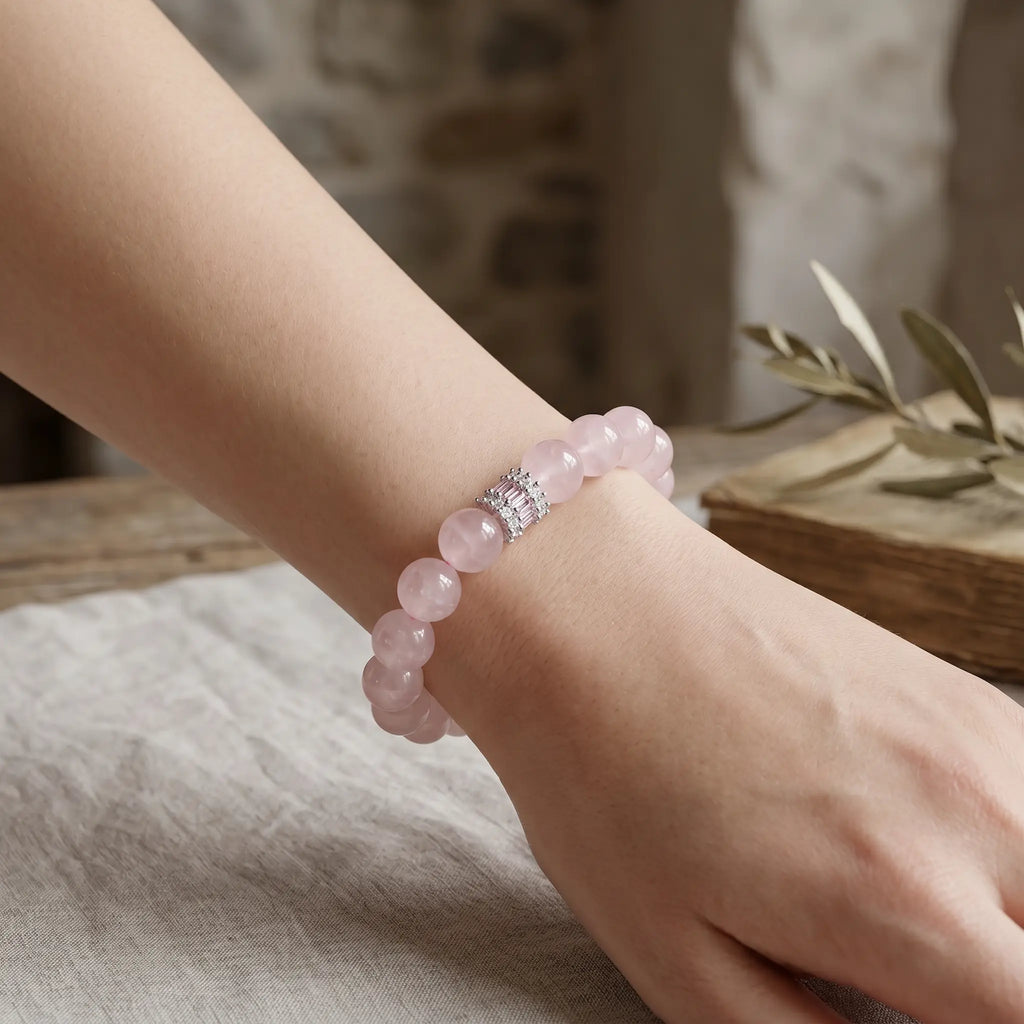 Diagonal perspective from top-left to bottom-right showcasing the detailed view of a pink crystal bracelet on a lady hand.