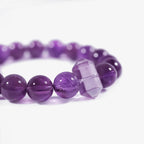 Cropped left-side half-view of the serene purple amethyst crystal bracelet on a pure white background.