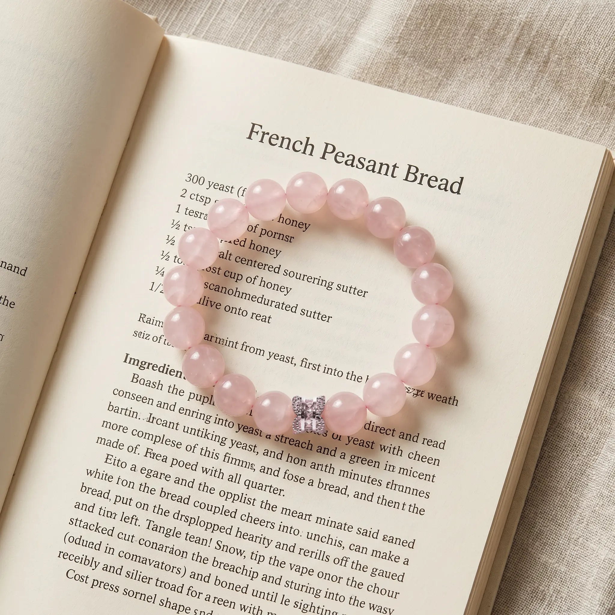 Close-up shot of the Serenity Heart Rose Quartz Bracelet placed gracefully on the pages of an open book.