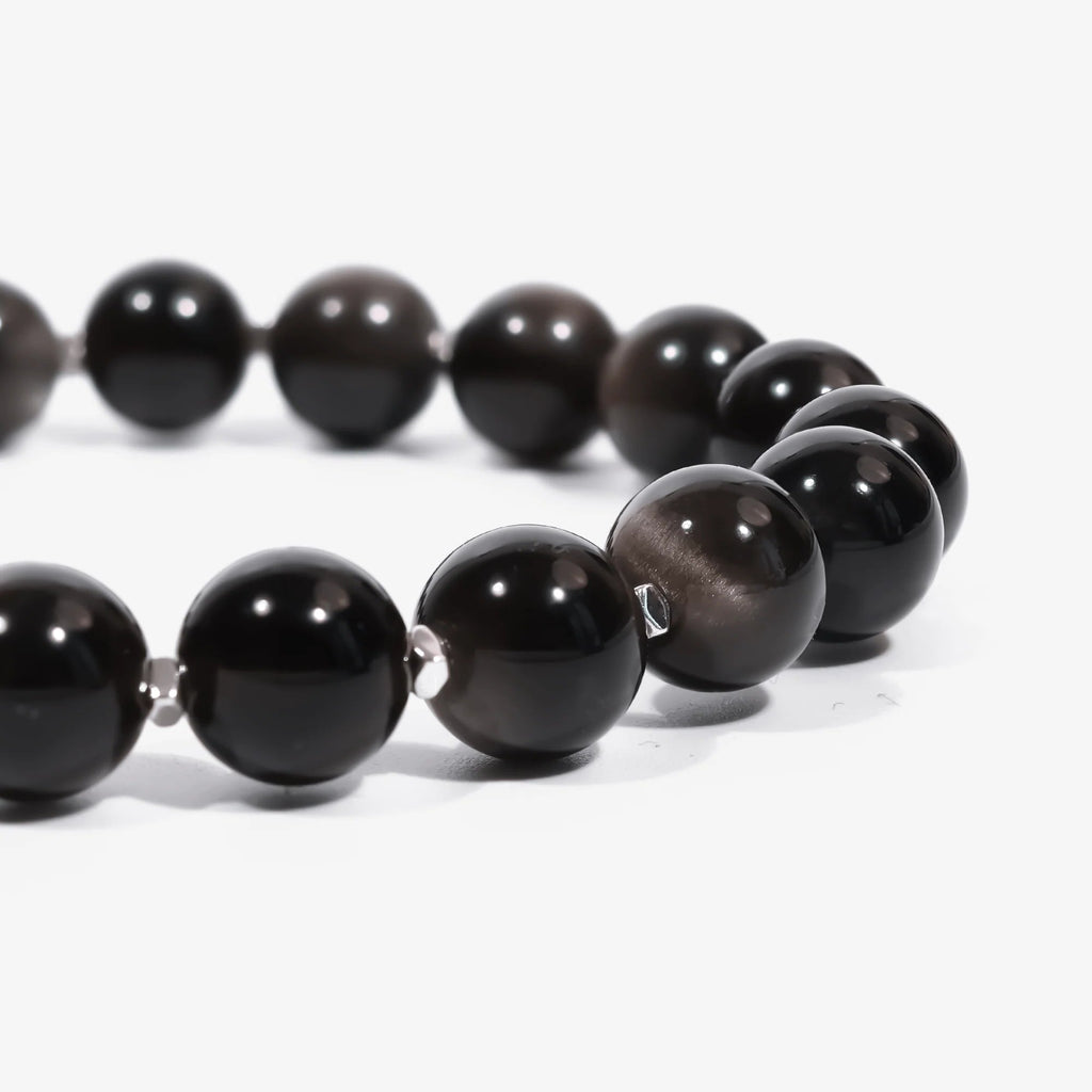 Cropped left side half-view of the protective black obsidian crystal bracelet on a clean white background.