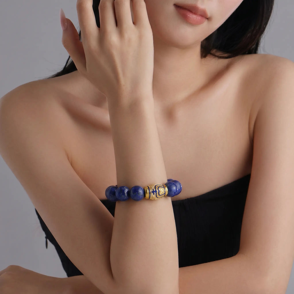 Front view portrait up to the chin showing a lady right forearm raised vertically wearing the Tranquil Lapis Bracelet.