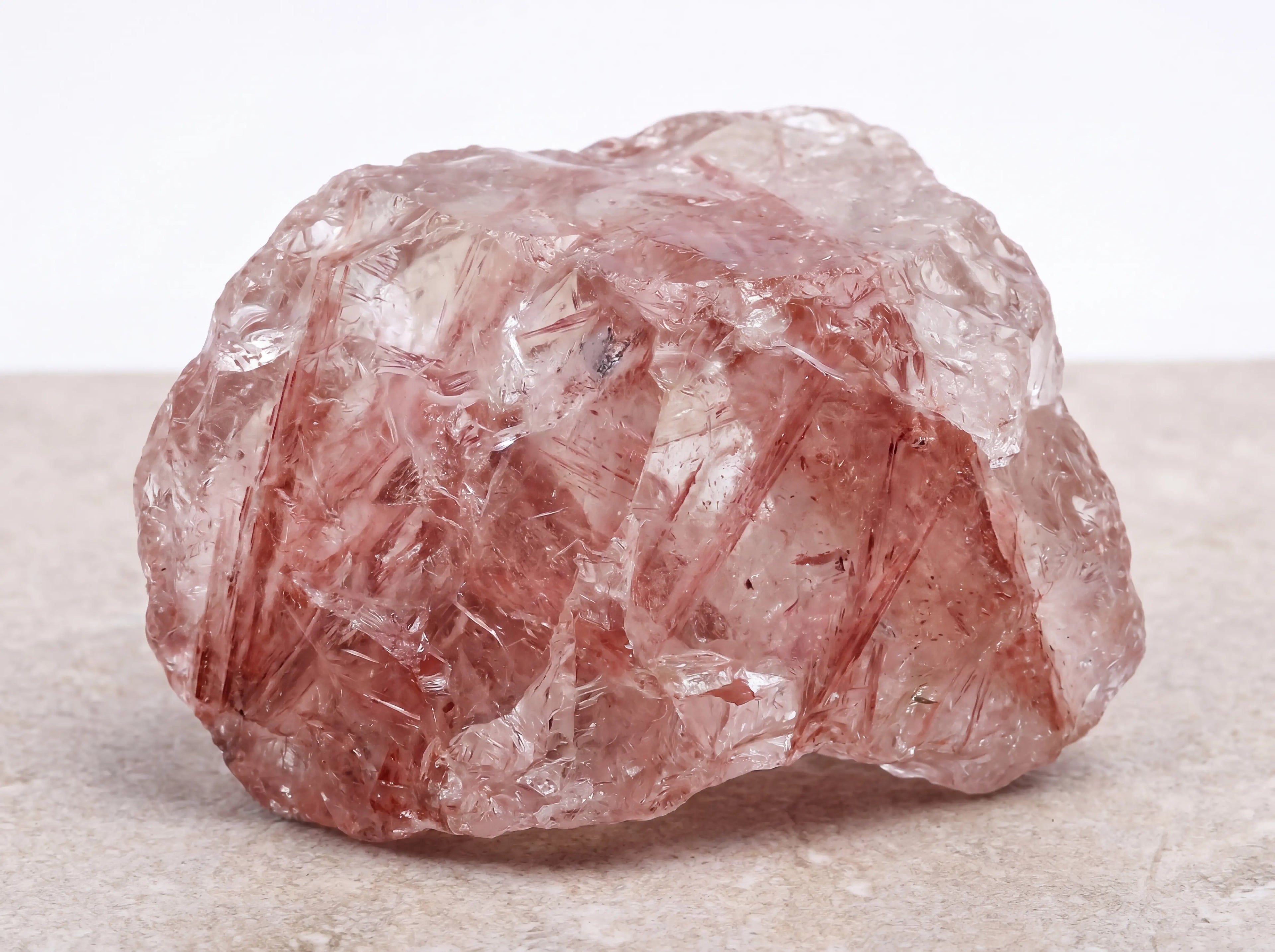 Aurora Bloom Strawberry natural rough strawberry quartz rock healing mineral crystal isolated on white.