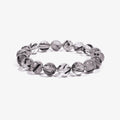 Studio product shot of Calm Armor Black Rutilated Quartz Bracelet isolated on a clean white background.
