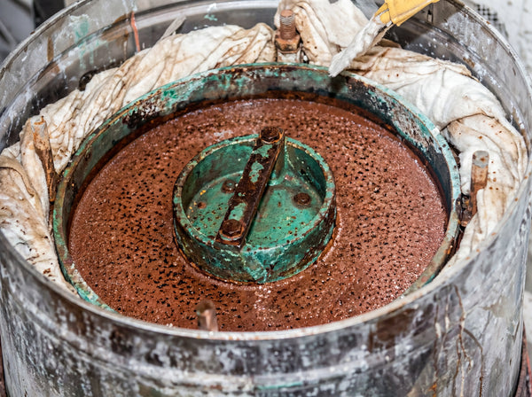 Rounding rough gemstone pieces into perfect spherical shapes during the handmade jewelry process.