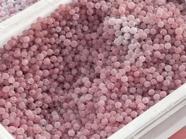 Polishing and smoothing handmade gemstone beads to achieve a high shine during the jewelry making process.