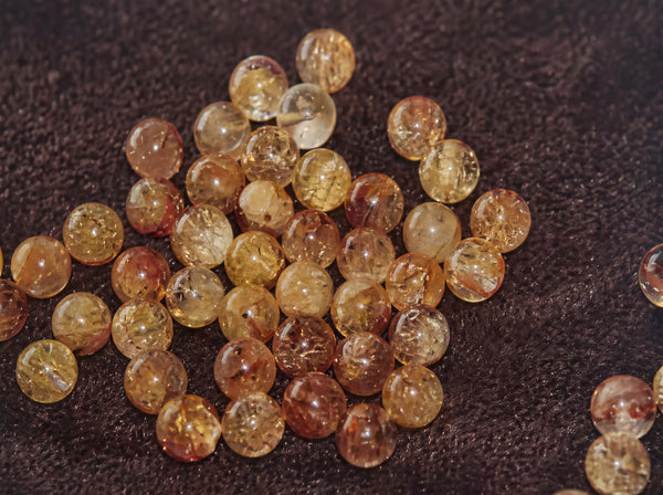 Boring micro holes through natural mineral crystal beads for premium handmade bracelets.
