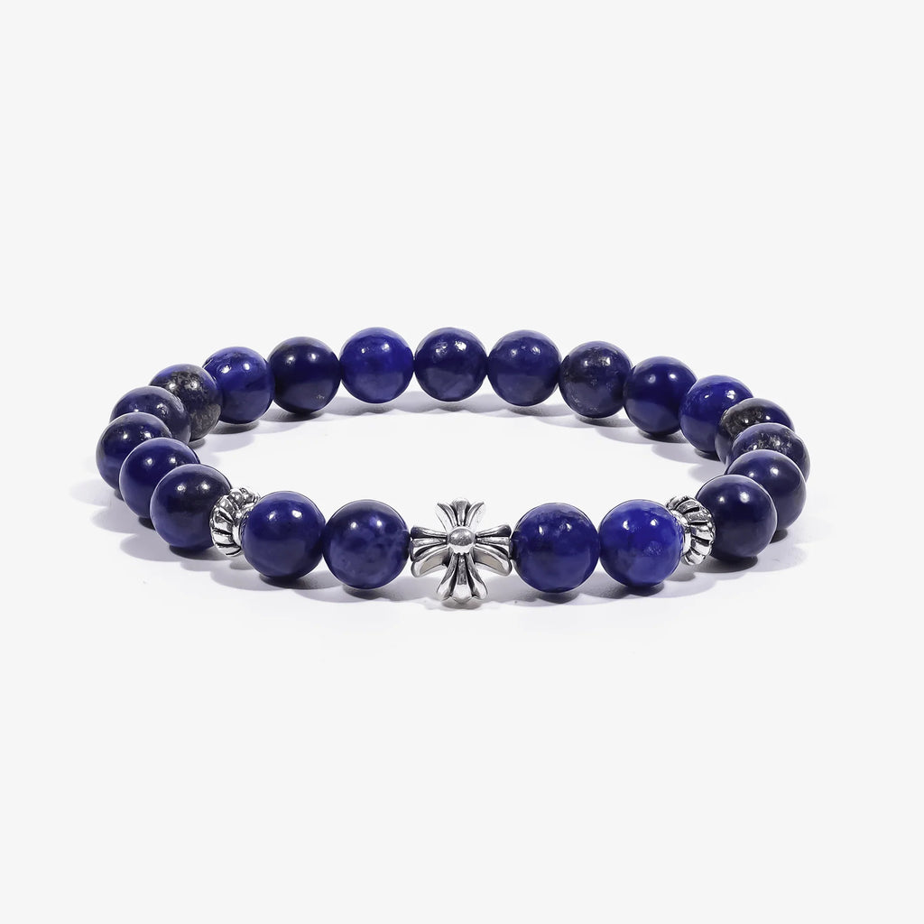 Studio product shot of Lucky Clarity Lapis Cross Bracelet isolated on a clean white background.