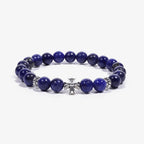 Studio product shot of Lucky Clarity Lapis Cross Bracelet isolated on a clean white background.
