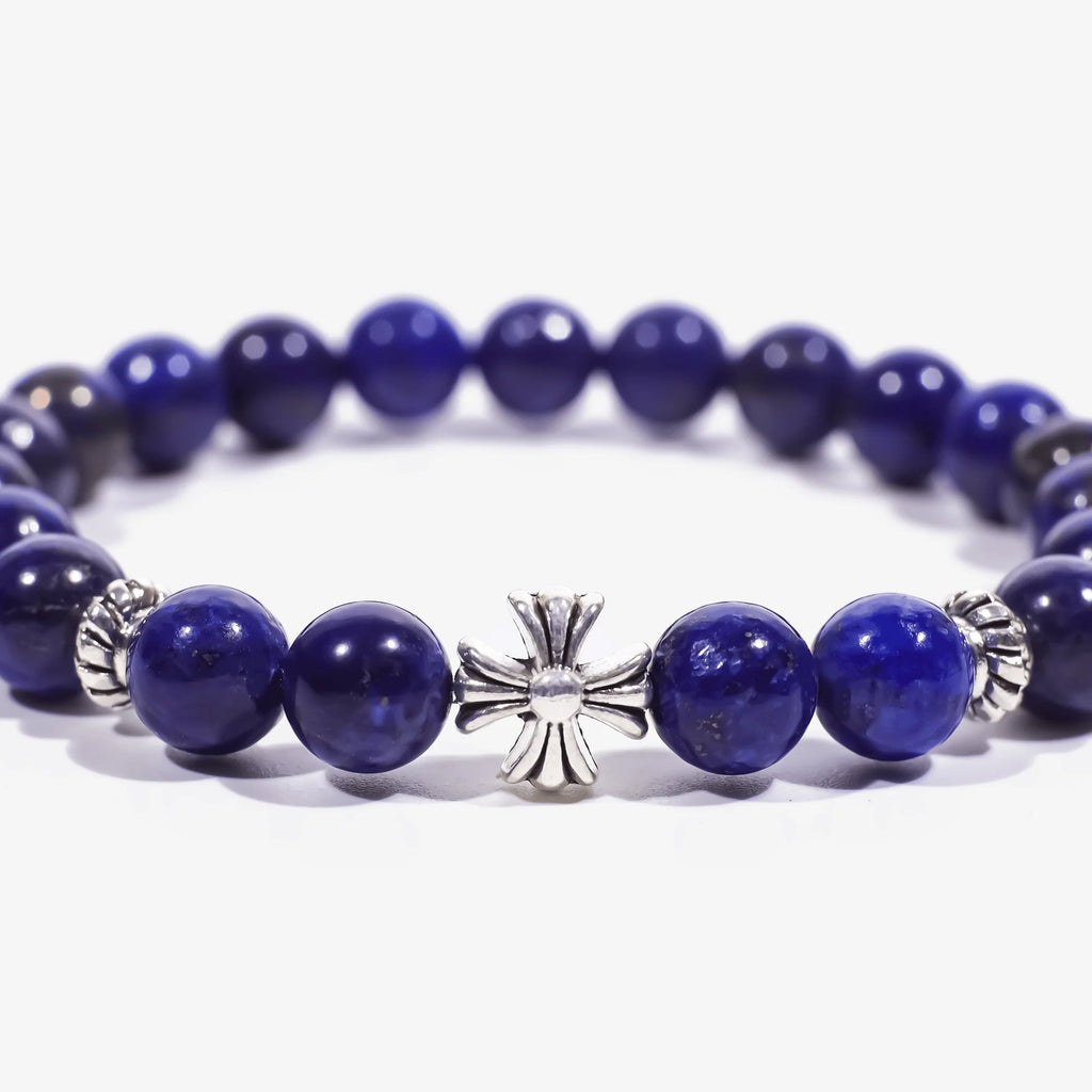 Enlarged central zoom view of the lapis lazuli cross bracelet on a white background with cropped left and right edges.