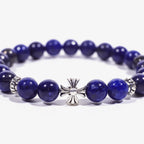 Enlarged central zoom view of the lapis lazuli cross bracelet on a white background with cropped left and right edges.