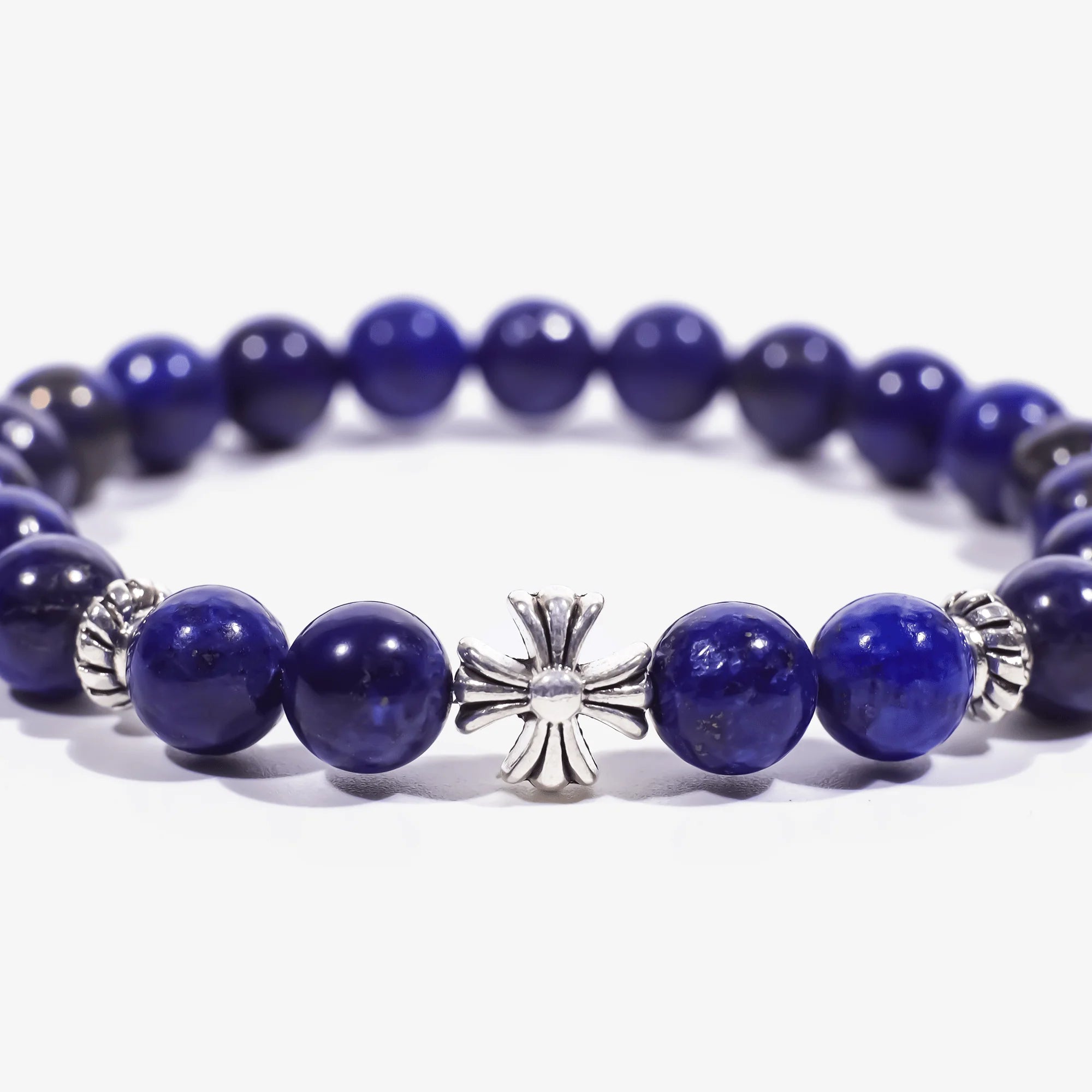 Enlarged central zoom view of the lapis lazuli cross bracelet on a white background with cropped left and right edges.