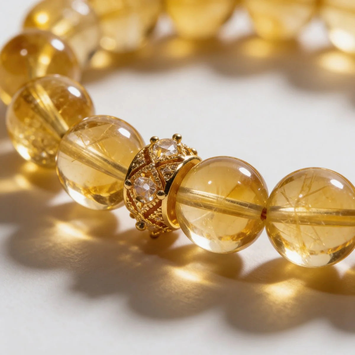 Cropped right-side half-view of the luxury Brazilian citrine quartz bracelet on a pure white background.